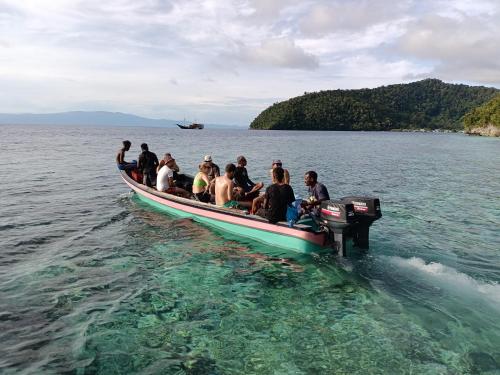 a group of people on a boat in the water at Warahnus dive homestay in Kri