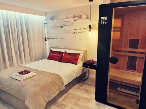 1 dormitorio con 1 cama con almohadas rojas en Apartament 34, en Ciechanów