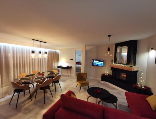 a living room with a red couch and a table and chairs at Apartament 34 in Ciechanów
