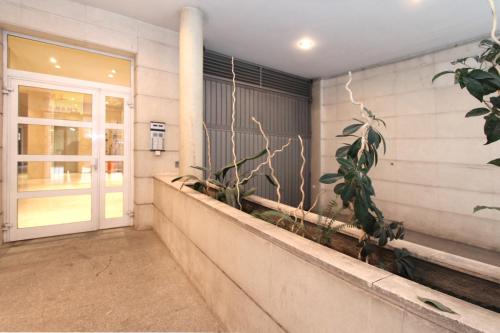 a porch with plants on the side of a building at Apartamento Silvela in Madrid