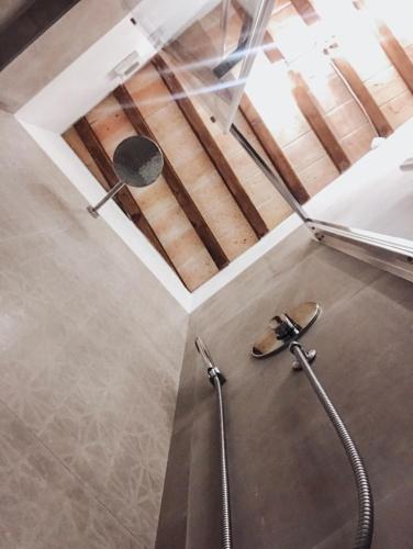 a shower in a bathroom with a glass ceiling at Antica Torre del Borgo in Certaldo