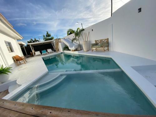 a swimming pool in the middle of a house at 4BlessingsCuracao2 in Willemstad