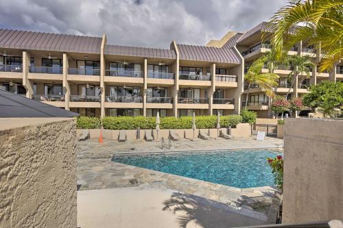 a resort with a swimming pool in front of a building at Downtown Kona Condo with Pool Access Walk to Beach! in Kailua-Kona