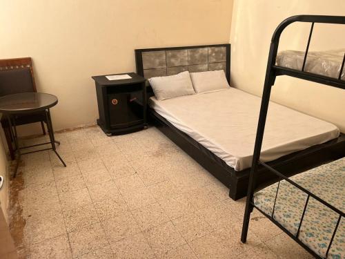 a bedroom with two bunk beds and a table at Gulf building, homestay in Sharjah