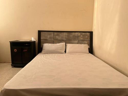 a bedroom with a large bed and a black cabinet at Gulf building, homestay in Sharjah