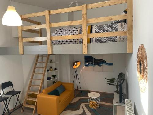 a living room with a bunk bed and a yellow couch at Sofieflat - Wallifolie in Charleroi