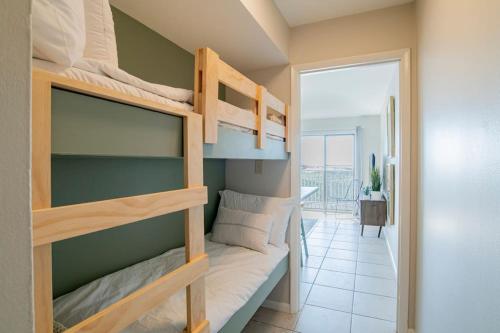 a bedroom with two bunk beds in a room at Beachfront Stylish Condo - Stunning Views! in Gulf Shores