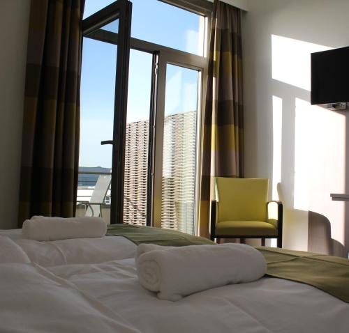 a bedroom with a bed with a view of the ocean at Mondo hôtel in Tubize