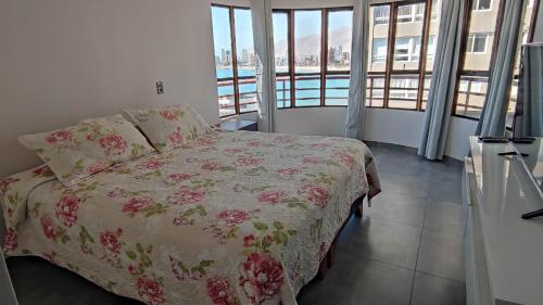 a bedroom with a bed and a view of the water at DEPTO SUITE II in Iquique