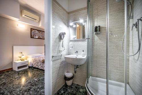 a bathroom with a tub and a sink and a shower at Maison Bianca B&B in Florence