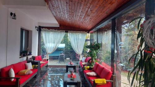 a living room with red couches and a table at Casa Daniel in Bran