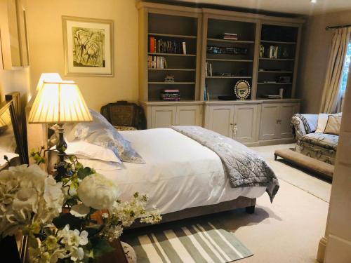 a bedroom with a bed and a living room at Bootmenders B&B in Petersfield