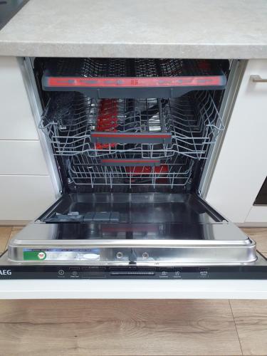 a dishwasher with a rack of tools in it at Dainai 1-Bedroom apartament. in Šiauliai