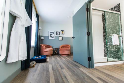 a room with a hallway with blue walls and a door at voco The Darwin - Atlanta Midtown by IHG in Atlanta