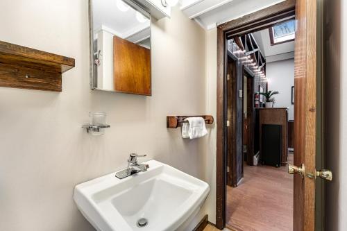 a bathroom with a sink and a mirror at Woodward Grove in Plymouth