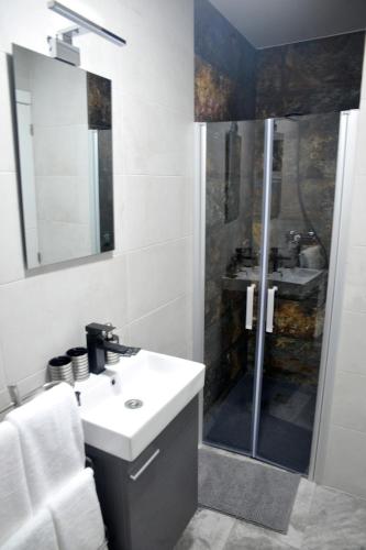 a white bathroom with a shower and a sink at River Dreams in Deltebre