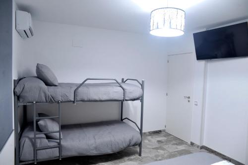 a room with two bunk beds and a light at River Dreams in Deltebre