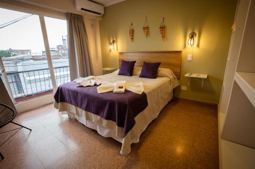 a bedroom with a bed with two towels on it at Samay Departamentos in Salta