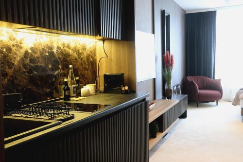 a kitchen with a counter top with a stove top oven at Superior Woodside Residences & Spa Kopaonik in Kopaonik