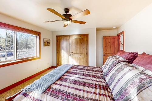a bedroom with a bed and a ceiling fan at Lakefront Paradise in Pagosa Springs