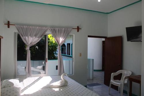 a bedroom with a bed with a swan on it at Hotel Gamito in Puerto Escondido
