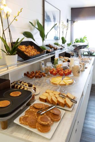 a buffet line with various pastries and other foods at Best Western Hotel Mediterranee Menton in Menton