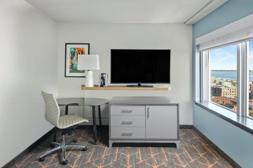 an office with a desk and a tv and a chair at Holiday Inn Portland-By the Bay by IHG in Portland