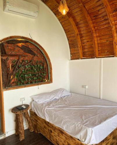 a bedroom with a bed with a wooden ceiling at Dream house in Dahab