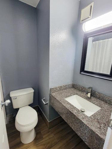 a bathroom with a toilet and a sink at Travel Inn San Antonio in San Antonio