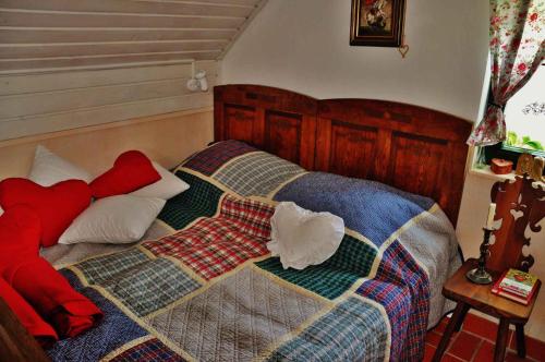 a bedroom with a bed with a quilt on it at Studio in Novo mesto - dostava - Kranjska Krain 26035 