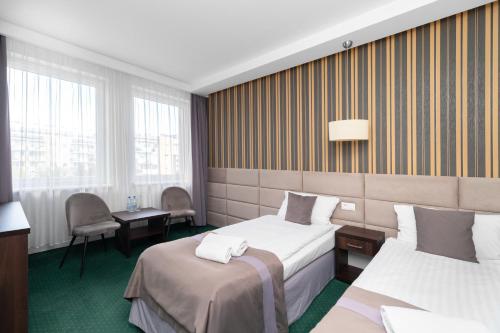 Säng eller sängar i ett rum på Hotel Maraton