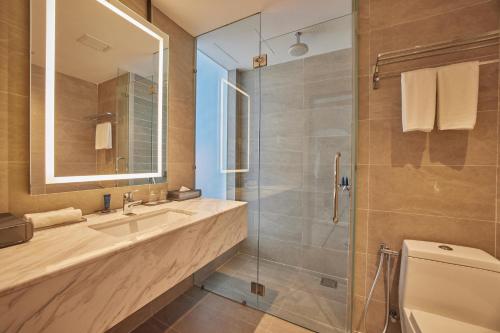 a bathroom with a toilet and a sink and a shower at Opero Hotel Southkey Johor Bahru in Johor Bahru