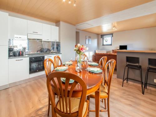 a kitchen and dining room with a table and chairs at Holiday home in Léglise with garden in Léglise