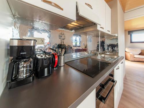 a kitchen with a coffee maker on a counter at Holiday home in Léglise with garden in Léglise