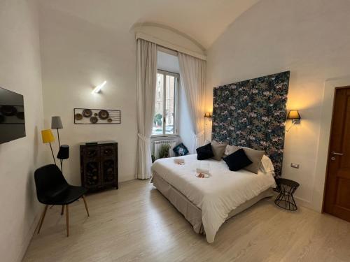 ein Schlafzimmer mit einem Bett, einem Stuhl und einem Fenster in der Unterkunft La tua casa nel centro di Roma in Rom