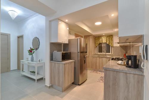 a kitchen with a stainless steel refrigerator and a counter at Dom. Rep. Exclusive 2 bed Apt. Evaristo Morales in Santo Domingo