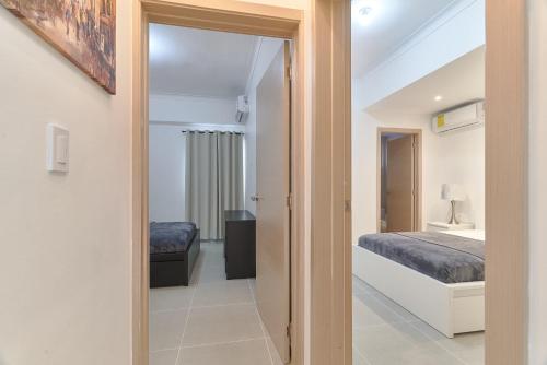 Postel nebo postele na pokoji v ubytování Dom. Rep. Exclusive 2 bed Apt. Evaristo Morales