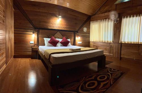 a bedroom with a bed in a wooden room at LAZY RETREAT in Vagamon