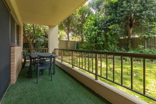 a patio with a table and chairs on a balcony at Wallis Gardens 11 in Forster