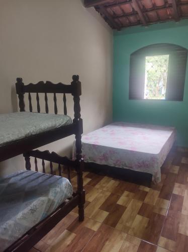 Tempat tidur dalam kamar di Edicula Lugar Tranquilo