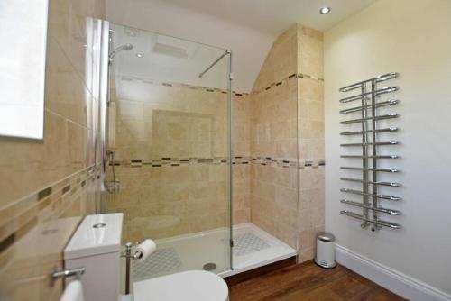 a bathroom with a shower and a toilet and a sink at Armstrong Cottages No22 in Bamburgh