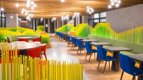 a restaurant with brightly colored chairs and tables and tablesktop at Hotel Indigo Alishan by IHG in Fanlu