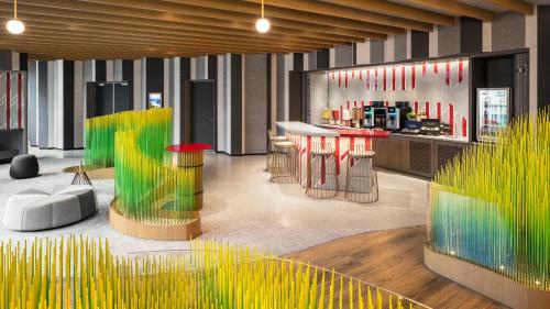 a lobby with yellow and red tables and chairs at Hotel Indigo Alishan by IHG in Fanlu
