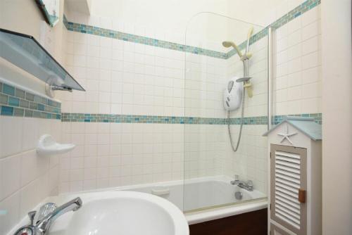 a bathroom with a sink and a tub and a shower at No9 Budle Sands in Bamburgh