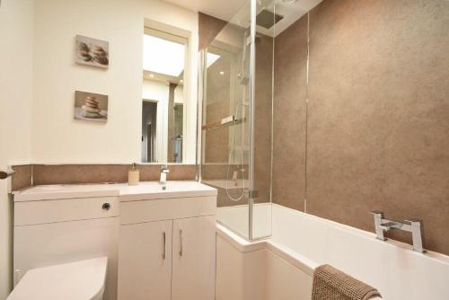 a bathroom with a toilet and a sink and a shower at Anchor Lodge in Seahouses