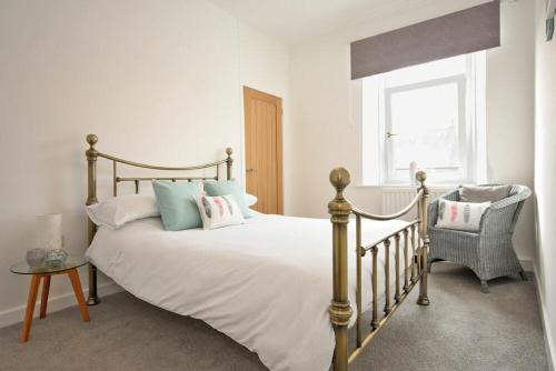 a bedroom with a large bed and a window at Castaway in Amble