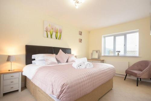 a bedroom with a large bed with towels on it at Viewpoint in Alnmouth