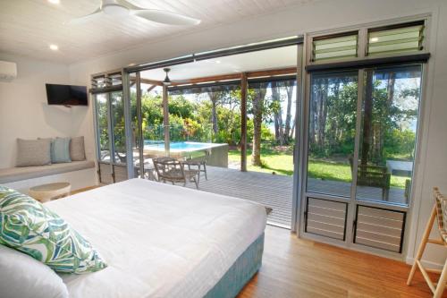 Ένα ή περισσότερα κρεβάτια σε δωμάτιο στο The Bungalows