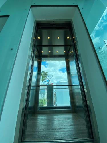 an elevator in a building with a view of the ocean at Wesberly Apartments in Kuching