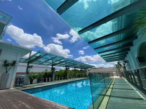 a swimming pool in the middle of a building at Wesberly Apartments in Kuching
